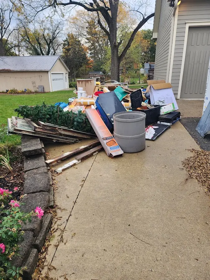 Dumpster being loaded with debris for Estate Cleanout Dumpster Rental in Haskell